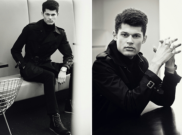 Fashion photography of young man with curly black hair modeling facing the photographer wearing a black suit and boots