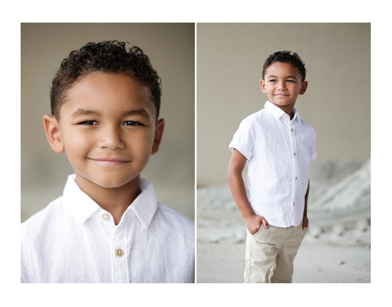 A young boy with short curly hair smiles, facing the photographer while wearing a white button-up shirt and khaki pants